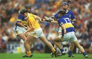 28 July 2002; Karl McKeegan of Antrim in action against Tipperary players, from left, Thomas Dunne, Eoin Kelly, 13, and Benny Dunne during the All-Ireland Senior Hurling Championship Quarter-Final match between Antrim and Tipperary at Croke Park in Dublin. Photo by Ray McManus/Sportsfile
