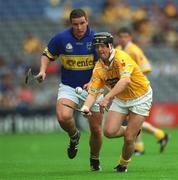 28 July 2002; Karl McKeegan of Antrim in action against John Carroll of Tipperary during the All-Ireland Senior Hurling Championship Quarter-Final match between Antrim and Tipperary at Croke Park in Dublin. Photo by Ray McManus/Sportsfile
