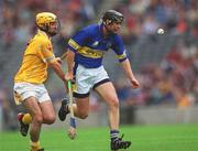 28 July 2002; Eddie Enright of Tipperary in action against Conor Cunning of Antrim during the All-Ireland Senior Hurling Championship Quarter-Final match between Antrim and Tipperary at Croke Park in Dublin. Photo by Ray McManus/Sportsfile