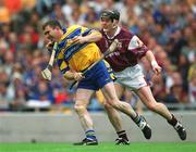 28 July 2002; Eugene Cloonan of Galway attempts to tackle Brian Quinn of Clare after he had broken his hurl on Quinn's forehead during the Guinness All-Ireland Senior Hurling Championship Quarter-Final match between Clare and Galway at Croke Park. Photo by Ray McManus/Sportsfile