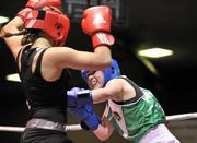 23 March 2012; Christine Gargan, Ireland, right, exchanges punches with Alicia Holsken, Holland, during their 52kg bout. Women's Boxing International, Ireland v Holland, National Stadium, Dublin. Picture credit: Barry Cregg / SPORTSFILE