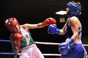 23 March 2012; Dervla Duffy, left, Ireland, exchanges punches with Kristen Frazser, Holland, during their 57kg bout. Women's Boxing International, Ireland v Holland, National Stadium, Dublin. Picture credit: Barry Cregg / SPORTSFILE