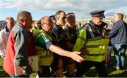 22 July 2017; Members of An Garda Síochána assist referee Ciarán Branagan from the field after the GAA Football All-Ireland Senior Championship Round 4A match between Cork and Mayo at Gaelic Grounds in Co. Limerick. Photo by Piaras Ó Mídheach/Sportsfile