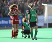 25 March 2012; A dejected Nicola Daly and Alexandra Speers, 9, Ireland, after the game as Belgium players celebrate. Women's Olympic Qualifying Tournament, Belgium v Ireland, Beerschot T.H.C., Kontich, Antwerp, Belgium. Picture credit: Stephen McCarthy / SPORTSFILE