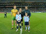 24 March 2012; Mascots Lauren Plummer, 11 years, from Donaghmede, and Luke Ennis, 10, from Coolock, with Dublin captain, Bryan Cullen, match referee Eddie Kinsella, and the Donegal captain, Michael Murphy, before the Allianz Football League Game, Croke Park, Dublin. Picture credit: Ray McManus / SPORTSFILE