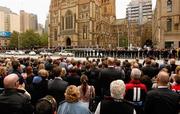 27 March 2012; Members of the public give a standing ovation after the funeral of former Melbourne player and president Jim Stynes. State Funeral for Jim Stynes, St Paul's Cathedral, Melbourne, Australia. Picture credit: Lachlan Cunningham / SPORTSFILE