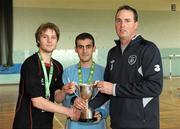 27 March 2012; Gerard Dunne, FAI, presents the cup to University College Cork joint captains Paul Westerhof, left, and Roberto Bernabeam Verdu. Colleges and Universities Futsal National Cup Finals, Gormanston College, Gormanston Co. Meath. Photo by Sportsfile