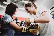 26 July 2017; Katie Taylor ties the gloves of 11 year old fan Jesselyn Silva during an open workout session in Modell's Sporting Goods in Brooklyn, New York, USA. Photo by Amanda Westcott/ SHOWTIME/ Sportsfile