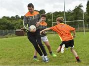 27 July 2017; Mayo's Lee Keegan in action with Fionn Curley and Dermot Daly during Lee Keegan's Kellogg’s GAA Cul Camps Surprise Visit at Leitrim Town Centre in Leitrim. Photo by Matt Browne/Sportsfile