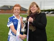 31 March 2012; The Colaiste Dun Iascaigh captain Emma Corcoran is presented with the cup by Marie Hickey, the Leinster President. Tesco All-Ireland Post Primary Schools Junior A Final, Colaiste Dun Iascaigh, Cahir, Co. Tipperary v Loreto Convent, Omagh, Co. Tyrone, Moate GAA Club, Hogan Park, Moate, Co. Westmeath. Picture credit: Ray McManus / SPORTSFILE