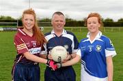 31 March 2012; The Colaiste Dun Iascaigh captain, Emma Corcoran, right, and the Loreto Convent captain, Niamh McGirr, shake hands accross referee Shaun Duane before the 'toss'. Tesco All-Ireland Post Primary Schools Junior A Final, Colaiste Dun Iascaigh, Cahir, Co. Tipperary v Loreto Convent, Omagh, Co. Tyrone, Moate GAA Club, Hogan Park, Moate, Co. Westmeath. Picture credit: Ray McManus / SPORTSFILE