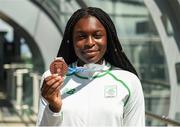 30 July 2017; Team Ireland arrive at Dublin Airport with 6 medals following competition at the 2017 European Youth Olympic Festival, EYOF, in Gyor, Hungary. The multi-sport event saw 40 Irish athletes, aged 14-16, compete against the best youth athletes in Europe. The six sports represented by Ireland were Athletics, Cycling, Swimming, Judo, Tennis and Gymnastics. Pictured is Team Ireland's Patience Jumbo Gula, from Dundalk, Co. Louth, with her bronze medal after coming third in the women's 100m final, at Dublin Airport, Dublin. Photo by Seb Daly/Sportsfile