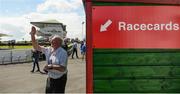 31 July 2017; A punter purchases a racecard during the Galway Races Summer Festival 2017 at Ballybrit, in Galway. Photo by Cody Glenn/Sportsfile