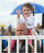 31 July 2017; A young racegoer cheers on the runners and riders during the Galway Races Summer Festival 2017 at Ballybrit, in Galway. Photo by Cody Glenn/Sportsfile