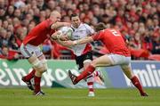 8 April 2012; Paddy Wallace, Ulster, is tackled by Paul O'Connell, left, and Mike Sherry, Munster. Heineken Cup Quarter-Final, Munster v Ulster, Thomond Park, Limerick. Picture credit: Stephen McCarthy / SPORTSFILE