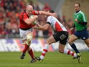 8 April 2012; Paul O'Connell, Munster, is tackled by Ruan Pienaar, Ulster. Heineken Cup Quarter-Final, Munster v Ulster, Thomond Park, Limerick. Picture credit: Stephen McCarthy / SPORTSFILE