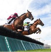 1 August 2017; Eventual winner Housesofparliament, right, with Barry Geraghty up, jump the fifth alongside Cinema De Quartier, with Bryan Cooper up, on their way to winning the Colm Quinn BMW Novice Hurdle during the Galway Races Summer Festival 2017 at Ballybrit, in Galway. Photo by Cody Glenn/Sportsfile