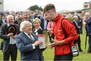 2 August 2017; The President of Ireland Michael D Higgins places a bet in the parade ring during the Galway Races Summer Festival 2017 at Ballybrit, in Galway. Photo by Cody Glenn/Sportsfile