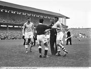 3 September 1961; Lar Foley, Dublin, right, selector Joe Drumgoole and Dublin captain Noel Drumgoole remonstrate with referee Gerry Fitzgerald after Foley was sent off in the 45th minute. GAA Hurling All-Ireland Senior Championship Final, Dublin v Tipperary, Croke Park, Dublin. Picture credit: Connolly Collection / SPORTSFILE