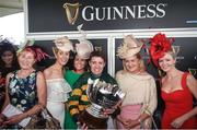 3 August 2017; Jockey Barry Geraghty celebrates with the trophy and friends including Geraghty's wife Paula Geraghty, fourth from left, and Noreen McManus, second from right, wife of owner JP McManus, after winning the Guinness Galway Hurdle Handicap on Tigris River during the Galway Races Summer Festival 2017 at Ballybrit, in Galway. Photo by Cody Glenn/Sportsfile