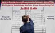 4 August 2017; Niall Rooney updates the jockey leaders board which his family has sponsored since 1966 awarding 2,000 euros and a Galway crystal vase to the winning jockeys of both National Hunt and flat racing during the Galway Races Summer Festival 2017 at Ballybrit, in Galway. Photo by Cody Glenn/Sportsfile