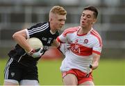 5 August 2017; Red Og Murphy of Sligo  in action against Conor McCluskey of Derry  during the Electric Ireland All-Ireland GAA Football Minor Championship Quarter-Final match between Derry and Sligo at Mac Cumhaill Park in Ballybofey, Donegal. Photo by Oliver McVeigh/Sportsfile