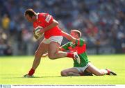 5 August 2002; Cork's Colin Corkery is tackled by Mayo's David Heany. Mayo v Cork, All Ireland Football Quarter - Final, Croke Park, Dublin. Picture credit; Ray McManus / SPORTSFILE