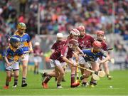 6 August 2017; Faye Mulrooney of Seir Kieran N.S., Co Mayo, representing Galway,  in action against Mary Hanrahan of Crusheen N.S., Co Clare, representing Tipperary, during INTO Cumann na mBunscol GAA Respect Exhibition Go Games at Galway v Tipperary - GAA Hurling All-Ireland Senior Championship Semi-Final at Croke Park in Dublin Photo by Ray McManus/Sportsfile