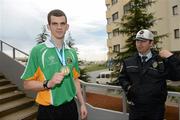 21 April 2012; Adam Nolan, Ireland, with his gold medal near the seafront in Trabzon, is watched by a local Policeman after victory over Patrick Wocicki, Germany, during the Final of the Welterweight 69kg division. AIBA European Olympic Boxing Qualifying Championships, Hayri Gür Arena, Trabzon, Turkey. Picture credit: David Maher / SPORTSFILE