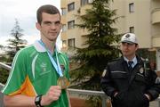 21 April 2012; Adam Nolan, Ireland, holding his gold medal near the seafront in Trabzon, is watched by a local Policeman after victory over Patrick Wocicki, Germany, during the Final of the Welterweight 69kg division. AIBA European Olympic Boxing Qualifying Championships, Hayri Gür Arena, Trabzon, Turkey. Picture credit: David Maher / SPORTSFILE