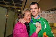 22 April 2012; Ireland's Adam Nolan, who won a gold medal at AIBA European Olympic Boxing Qualifying Championships and qualification for the London Games 2012, celebrates with his mother Anne, on his arrival in Dublin Airport following the qualifying Championships in Trabzon, Turkey. Dublin Airport, Dublin. Picture credit: David Maher / SPORTSFILE