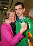 22 April 2012; Ireland's Adam Nolan, who won a gold medal at AIBA European Olympic Boxing Qualifying Championships and qualification for the London Games 2012, celebrates with his mother Anne, on his arrival in Dublin Airport following the qualifying Championships in Trabzon, Turkey. Dublin Airport, Dublin. Picture credit: David Maher / SPORTSFILE