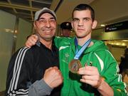 22 April 2012; Ireland's Adam Nolan, who won a gold medal at AIBA European Olympic Boxing Qualifying Championships and qualification for the London Games 2012, celebrates with his coach Pete Taylor, on his arrival in Dublin Airport following the qualifying Championships in Trabzon, Turkey. Dublin Airport, Dublin. Picture credit: David Maher / SPORTSFILE