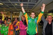 22 April 2012; Ireland's Adam Nolan, who won a gold medal at AIBA European Olympic Boxing Qualifying Championships and qualification for the London Games 2012, celebrates with family and friends on his arrival in Dublin Airport following the qualifying Championships in Trabzon, Turkey. Dublin Airport, Dublin. Picture credit: David Maher / SPORTSFILE
