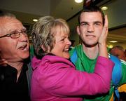 22 April 2012; Ireland's Adam Nolan, who won a gold medal at AIBA European Olympic Boxing Qualifying Championships and qualification for the London Games 2012, celebrates with his mother Anne and father John, on his arrival in Dublin Airport following the qualifying Championships in Trabzon, Turkey. Dublin Airport, Dublin. Picture credit: David Maher / SPORTSFILE