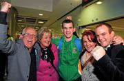 22 April 2012; Ireland's Adam Nolan, who won a gold medal at AIBA European Olympic Boxing Qualifying Championships and qualification for the London Games 2012, celebrates with family members, from left, John, father, Anne, mother, Leanne, sister, and Darren, brother, on his arrival in Dublin Airport following the qualifying Championships in Trabzon, Turkey. Dublin Airport, Dublin. Picture credit: David Maher / SPORTSFILE