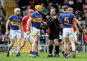 22 April 2012; Referee Michael Wedding restrains Tipperary captain Padraic Maher. Allianz Hurling League Division 1A Semi-Final, Cork v Tipperary, Semple Stadium, Thurles, Co. Tipperary. Picture credit: Brian Lawless / SPORTSFILE