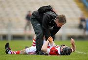 22 April 2012; Donal Og Cusack, Cork, is attended to by team physiotherapist Declan O'Sullivan after picking up an injury during the first half. Allianz Hurling League Division 1A Semi-Final, Cork v Tipperary, Semple Stadium, Thurles, Co. Tipperary. Picture credit: Stephen McCarthy / SPORTSFILE
