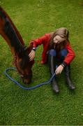 8 August 2017; Olivia Devereaux, age 11, from Cahir, Co Tipperary, comforts her showjumping horse named Munsboro Plunkett, while he eats his lunch ahead of the Dublin Horse Show at the RDS in Ballsbridge, Dublin. The pair will compete on Wednesday and Thursday in the 128cm youth showjumping category. Photo by Cody Glenn/Sportsfile