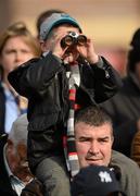 24 April 2012; Jake Thomas, age 5, from Chapelizod, Dublin, uses his binoculars to check the form on the big screen as he sits on his father Seamus' shoulders ahead of the Goffs Land Rover Bumper. Punchestown Racing Festival, Punchestown Racecourse, Punchestown, Co. Kildare. Picture credit: Barry Cregg / SPORTSFILE