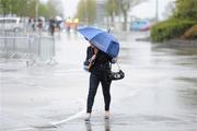 25 April 2012; Madeline Lynch, from Skerries, Co. Dublin, arrives during heavy rain for the second day of the Punchestown Racing Festival. Punchestown Racecourse, Punchestown, Co. Kildare. Picture credit: Stephen McCarthy / SPORTSFILE