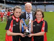 8 May 2012; Scoil Muire is Seosamh Bayside team-mates and sisters Sarah Cosgrave, left, and Hannah Cosgrave are presented with the cup by Tadhg Kenny, Cumann na mBunscol. Allianz Cumann na mBunscol Finals, Scoil Divine Word Marley v Scoil Muire is Seosamh Bayside, Croke Park, Dublin. Picture credit: Ray McManus / SPORTSFILE