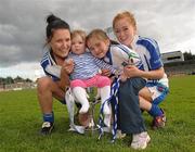 12 May 2012; Sisters Therese, left, and Grainne McNally, Monaghan, celebrate with their nieces Karen and Aoibhinn McCormack and the cup after the game. Bord Gáis Energy Ladies National Football League, Division 1 Final, Cork v Monaghan, Parnell Park, Dublin. Photo by Sportsfile
