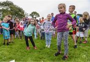 20 August 2017; Parkrun Ireland, in partnership with Vhi, expanded their range of junior events to ten with the introduction of the Oranmore Junior Parkrun on Sunday morning. Junior parkruns are 2km long and cater for 4 to 14 year olds, free of charge providing a fun and safe environment for children to enjoy exercise. To register for a parkrun near you visit www.parkrun.ie. New registrants should select their chosen event as their home location. You will then receive a personal barcode which acts as your free entry to any parkrun event worldwide. Pictured are participants including Emily Fallon, aged 6, left, and Anna Finlay, aged 5, from Oranmore, Co Galway, warming up ahead of the Oranmore Junior Parkrun in partnership with Vhi. Rinville Park, Oranmore, Co Galway. Photo by Diarmuid Greene/Sportsfile