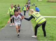 20 August 2017; Parkrun Ireland, in partnership with Vhi, expanded their range of junior events to ten with the introduction of the Oranmore Junior Parkrun on Sunday morning. Junior parkruns are 2km long and cater for 4 to 14 year olds, free of charge providing a fun and safe environment for children to enjoy exercise. To register for a parkrun near you visit www.parkrun.ie. New registrants should select their chosen event as their home location. You will then receive a personal barcode which acts as your free entry to any parkrun event worldwide. Pictured during the Oranmore Junior Parkrun, in partnnership with Vhi is Jonathan Smith, aged 8, from Oranmore, getting a high-five from Parkrun volunteer Emer McCarthy. Rinville Park, Oranmore, Co Galway. Photo by Diarmuid Greene/Sportsfile
