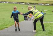 20 August 2017; Parkrun Ireland, in partnership with Vhi, expanded their range of junior events to ten with the introduction of the Oranmore Junior Parkrun on Sunday morning. Junior parkruns are 2km long and cater for 4 to 14 year olds, free of charge providing a fun and safe environment for children to enjoy exercise. To register for a parkrun near you visit www.parkrun.ie. New registrants should select their chosen event as their home location. You will then receive a personal barcode which acts as your free entry to any parkrun event worldwide. Pictured during the Oranmore Junior Parkrun, in partnership with Vhi is Aidan Cahalane, aged 7, from Claregalway, getting a high-five from Parkrun volunteer Emer McCarthy. Rinville Park, Oranmore, Co Galway. Photo by Diarmuid Greene/Sportsfile