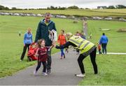 20 August 2017; Parkrun Ireland, in partnership with Vhi, expanded their range of junior events to ten with the introduction of the Oranmore Junior Parkrun on Sunday morning. Junior parkruns are 2km long and cater for 4 to 14 year olds, free of charge providing a fun and safe environment for children to enjoy exercise. To register for a parkrun near you visit www.parkrun.ie. New registrants should select their chosen event as their home location. You will then receive a personal barcode which acts as your free entry to any parkrun event worldwide. Pictured during the Oranmore Junior Parkrun, in partnership with Vhi is Rosin Coffey, aged 3, from Oranmore, along with her dad Fergal Coffey, getting a high-five from Parkrun volunteer Emer McCarthy. Rinville Park, Oranmore, Co Galway. Photo by Diarmuid Greene/Sportsfile