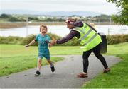 20 August 2017; Parkrun Ireland, in partnership with Vhi, expanded their range of junior events to ten with the introduction of the Oranmore Junior Parkrun on Sunday morning. Junior parkruns are 2km long and cater for 4 to 14 year olds, free of charge providing a fun and safe environment for children to enjoy exercise. To register for a parkrun near you visit www.parkrun.ie. New registrants should select their chosen event as their home location. You will then receive a personal barcode which acts as your free entry to any parkrun event worldwide. Pictured are participants with volunteer Bernie Rogers during the Oranmore Junior Parkrun, in partnership with Vhi. Rinville Park, Oranmore, Co Galway. Photo by Diarmuid Greene/Sportsfile