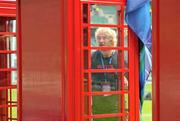 19 May 2012; Ulster's Paddy McAllister has a look in a telephone booth, which is part of the pre-match entertainment, before the game. Heineken Cup Final, Leinster v Ulster, Twickenham Stadium, Twickenham, England. Picture credit: Diarmuid Greene / SPORTSFILE