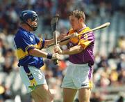 11 August 2002; Trevor Ivors of Tipperary and Andrew Kavanagh of Wexford tussle off the ball during the All-Ireland Minor Hurling Championship Semi-Final match between Wexford and Tipperary at Croke Park in Dublin. Photo by Brian Lawless/Sportsfile